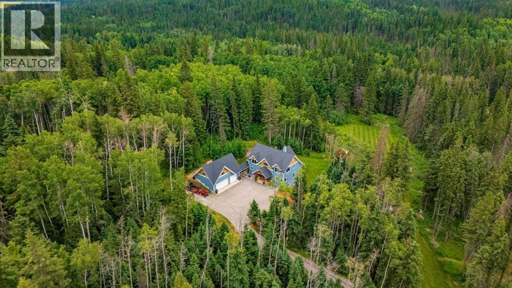 Set among 9.26 private, heavily treed acres, this ... - Image 1